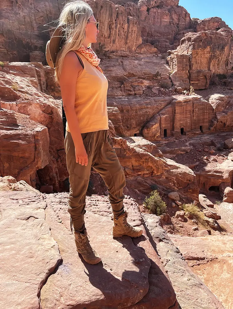 woman standing by red rocks